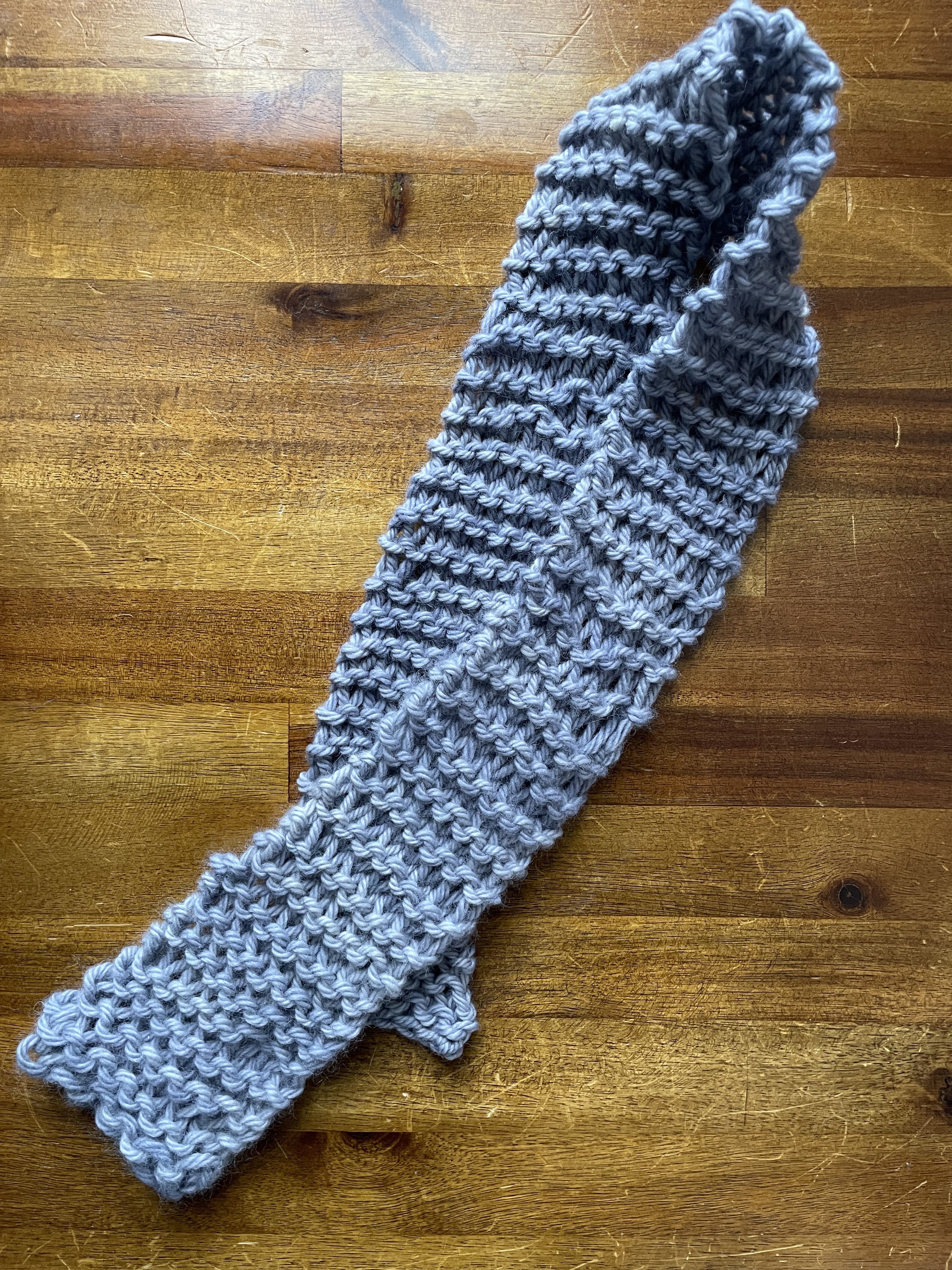 a thin, knit grey scarf